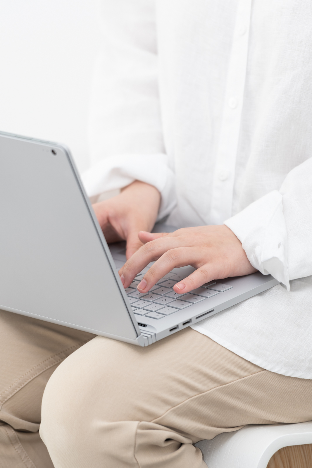 Financial Stock Images - Woman working from home-beige-laptop, typing, studying, female.