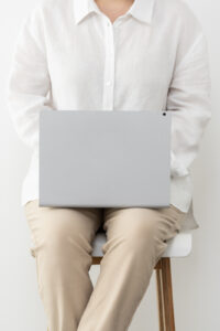 Financial Stock Images - Woman working from home-beige-laptop, typing, studying.