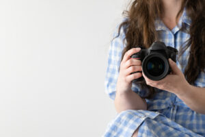 Financial Stock Images - Working from home-Photographer with camera in hand.