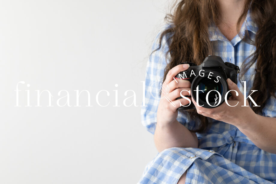 Financial Stock Images - Working from home-Photographer with camera in hand.