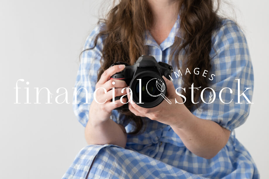 Financial Stock Images - Working from home-Photographer with camera in hand.