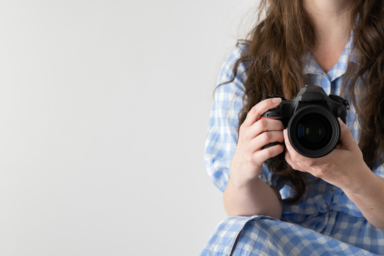 Financial Stock Images - Working from home-Photographer with camera in hand.