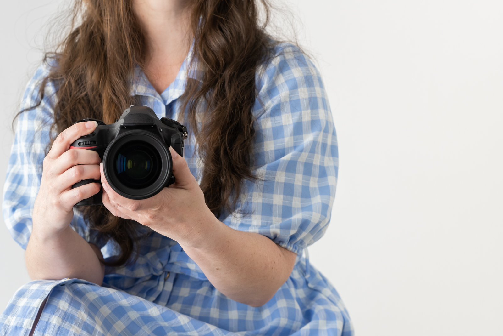 Financial Stock Images - Working from home-Photographer with camera in hand.