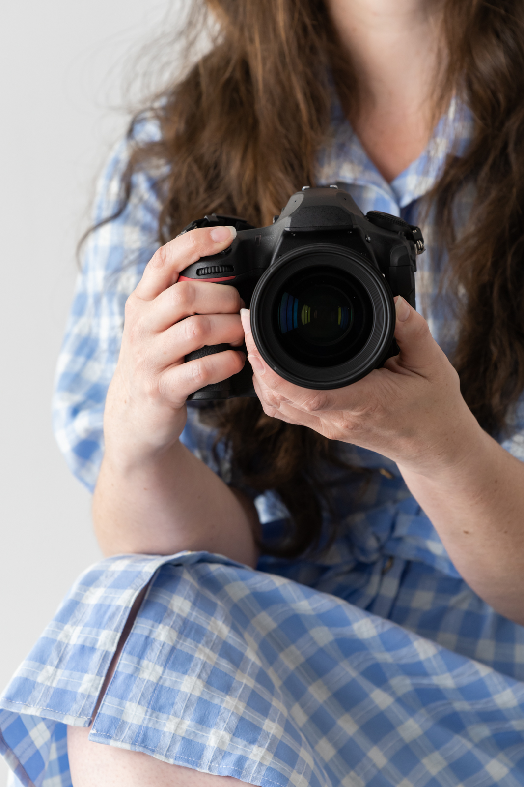 Financial Stock Images - Working from home-Photographer with camera in hand.