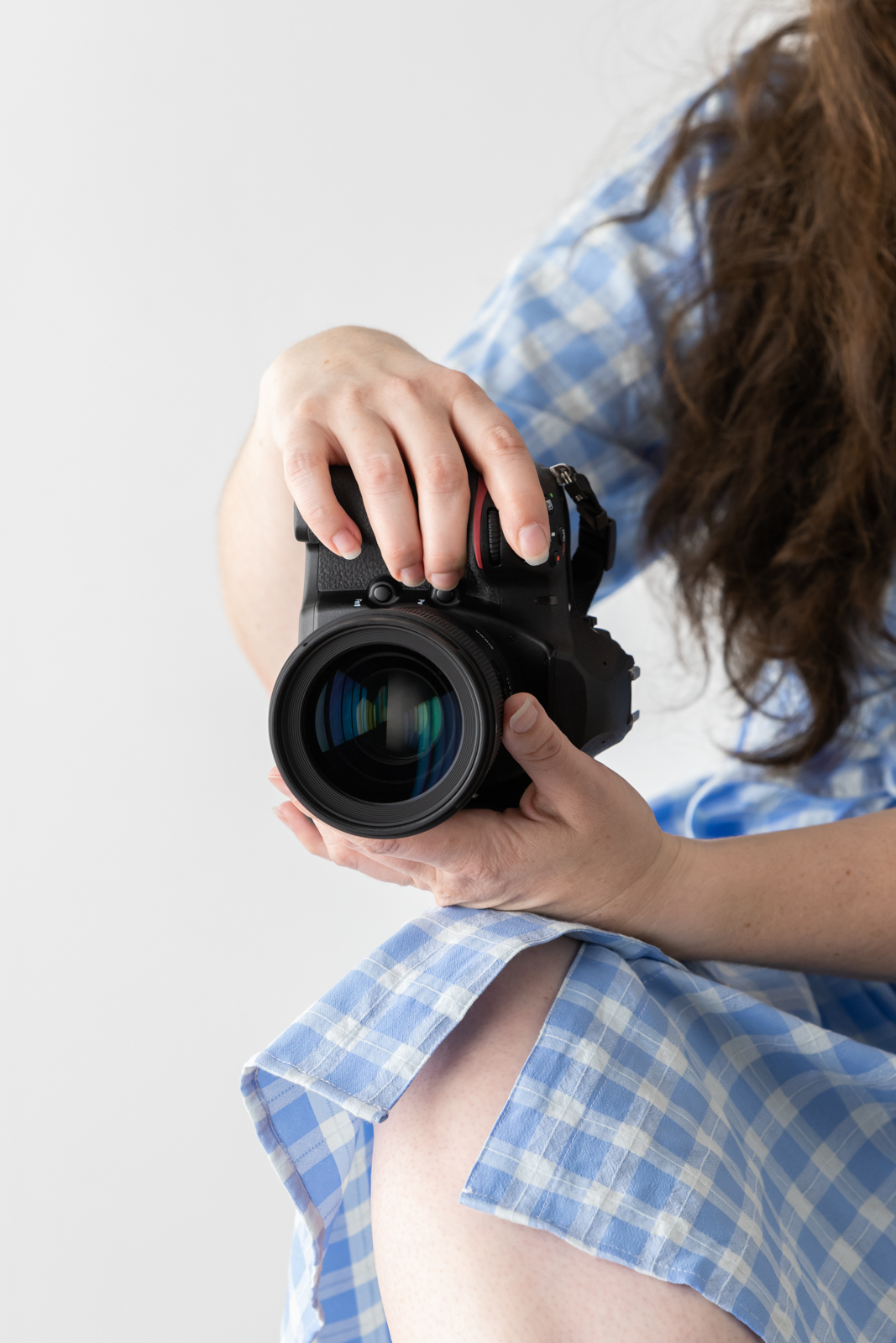 Financial Stock Images - Working from home-Photographer with camera in hand.