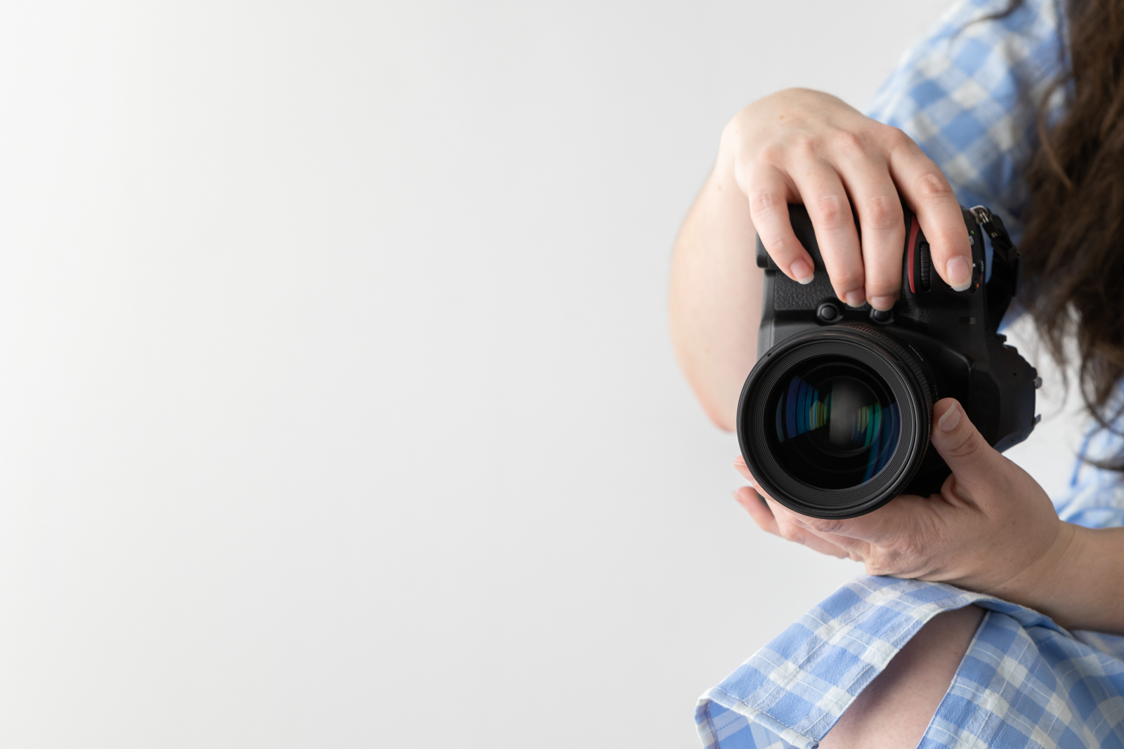 Financial Stock Images - Working from home-Photographer with camera in hand.