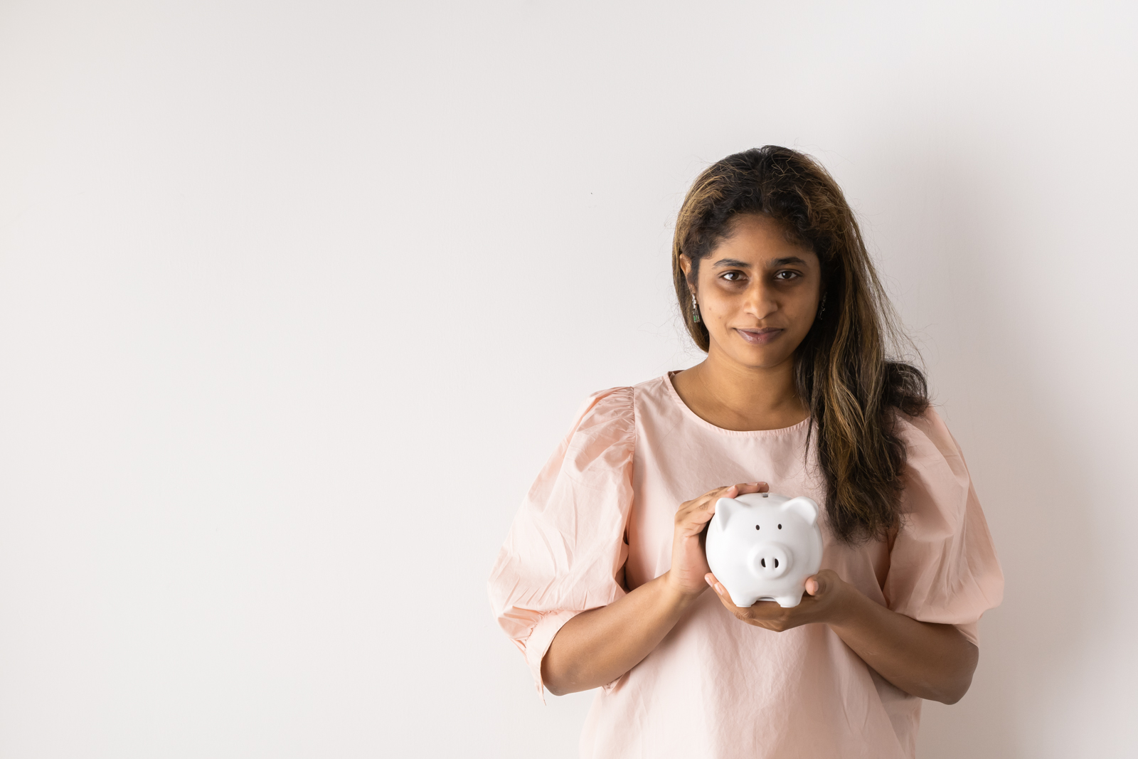 Financial Stock Images - Female entrepreneur working out her savings.