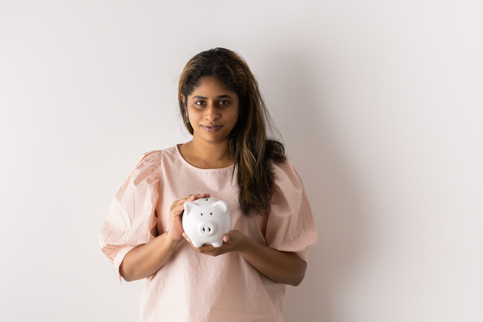 Financial Stock Images - Female entrepreneur working out her savings.